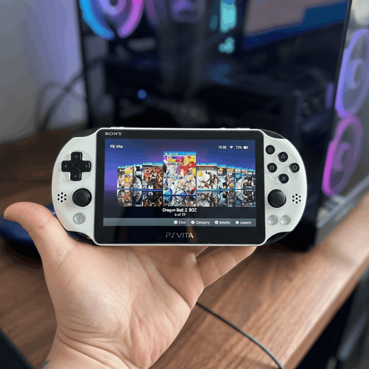 Modded PS Vita handheld console displaying game library, held in hand — pre-modded by ModxGaming UK