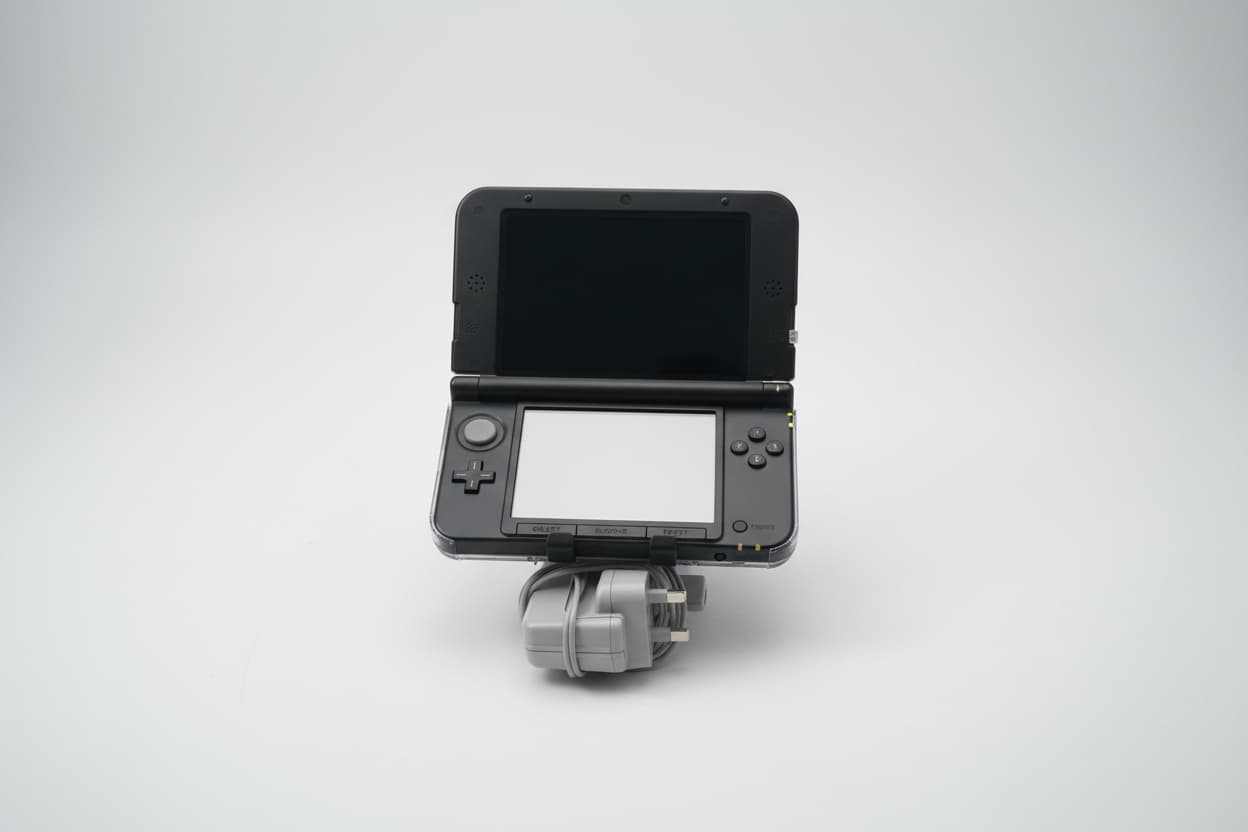 Black modified Nintendo 3DS XL with wrist strap, Luma3DS custom firmware, and homebrew emulators
