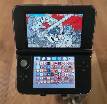 Nintendo 3DS gaming console with a colorful game displayed on the screen. Modified Nintendo 3DS XL with custom firmware, Luma3DS, homebrew apps, emulators, customizable themes, and enhanced performance features.