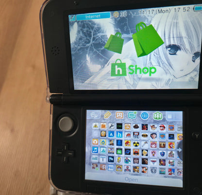 Nintendo 3DS displaying a shopping app interface on the screen Modified Nintendo 3DS XL with custom firmware, Luma3DS, homebrew apps, emulators, customizable themes, and enhanced performance features.