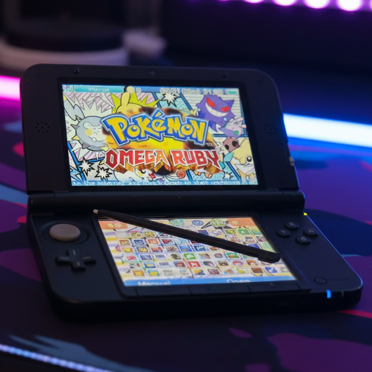 Modded Nintendo 3DS XL black playing colourful preloaded game with neon blue gaming atmosphere