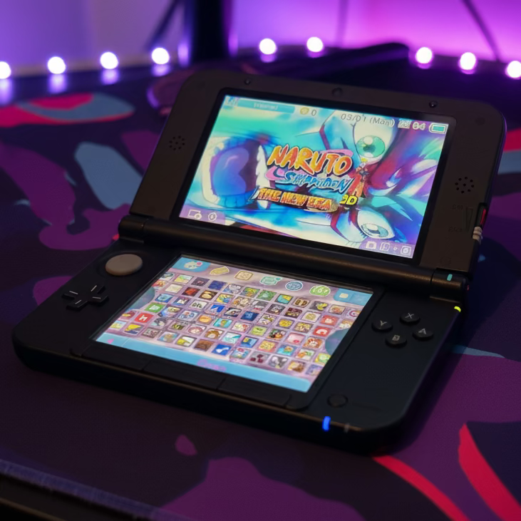 Modded Nintendo 3DS XL black with preloaded games on display in neon purple gaming setup