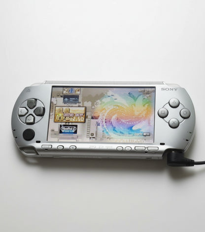 Sony portable gaming device on a white background “Ice silver modded PSP 1000 with 128GB SD card, custom firmware, emulators and pre installed games”

“Sony PSP 1000 ice silver jailbroken console featuring 128GB storage, custom firmware and classic games”

“PSP 1000 ice silver modded handheld with custom firmware, emulator support, and 128GB SD card included”