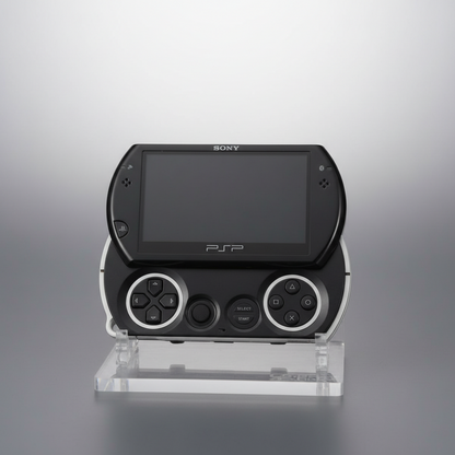 Black Sony PSP gaming console on a clear stand against a gray background Black Sony PSP Go modded handheld console with custom firmware and emulators pre-installed, portable retro gaming system for PlayStation and classic console games