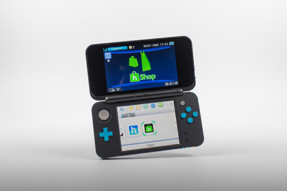 Dual-screen handheld device with app interfaces on a white background Hand holding a Nintendo Switch with a screen displaying a theme selection Modded Nintendo 2DS blue console 128GB SD custom firmware pre-loaded retro games emulators homebrew menu UK moddingmenu. Custom modded handheld 128GB SD card pre-loaded homebrew games emulators UK professional gaming mod service