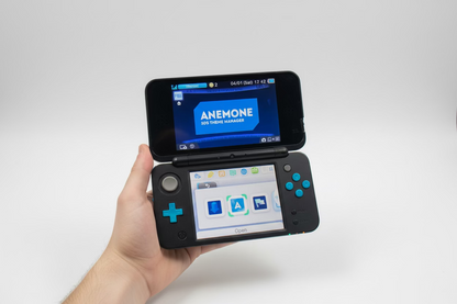 Hand holding a dual-screen device with 'Anemone' software displayed on a white background Hand holding a Nintendo Switch with a screen displaying a theme selection Modded Nintendo 2DS blue console 128GB SD custom firmware pre-loaded retro games emulators homebrew menu UK moddingmenu. Custom modded handheld 128GB SD card pre-loaded homebrew games emulators UK professional gaming mod service
