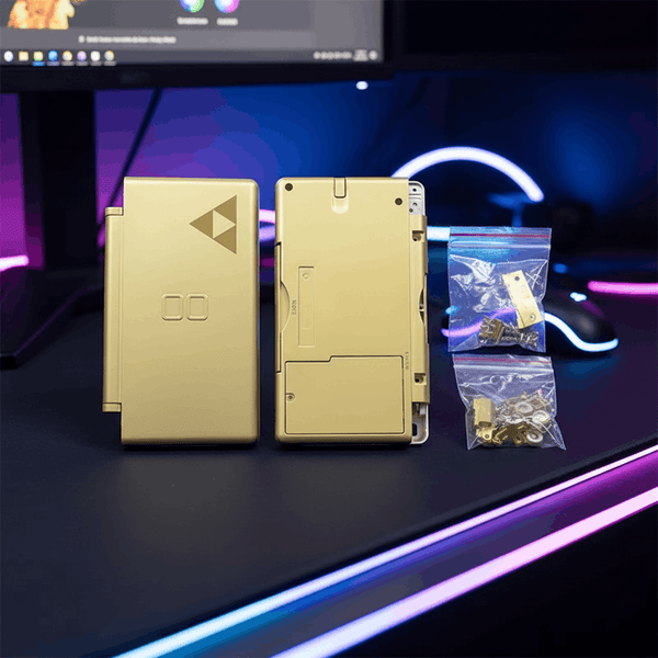 Gold Zelda Triforce Nintendo DS Lite replacement shell case mod kit on gaming desk with RGB lighting, including screws and hardware
