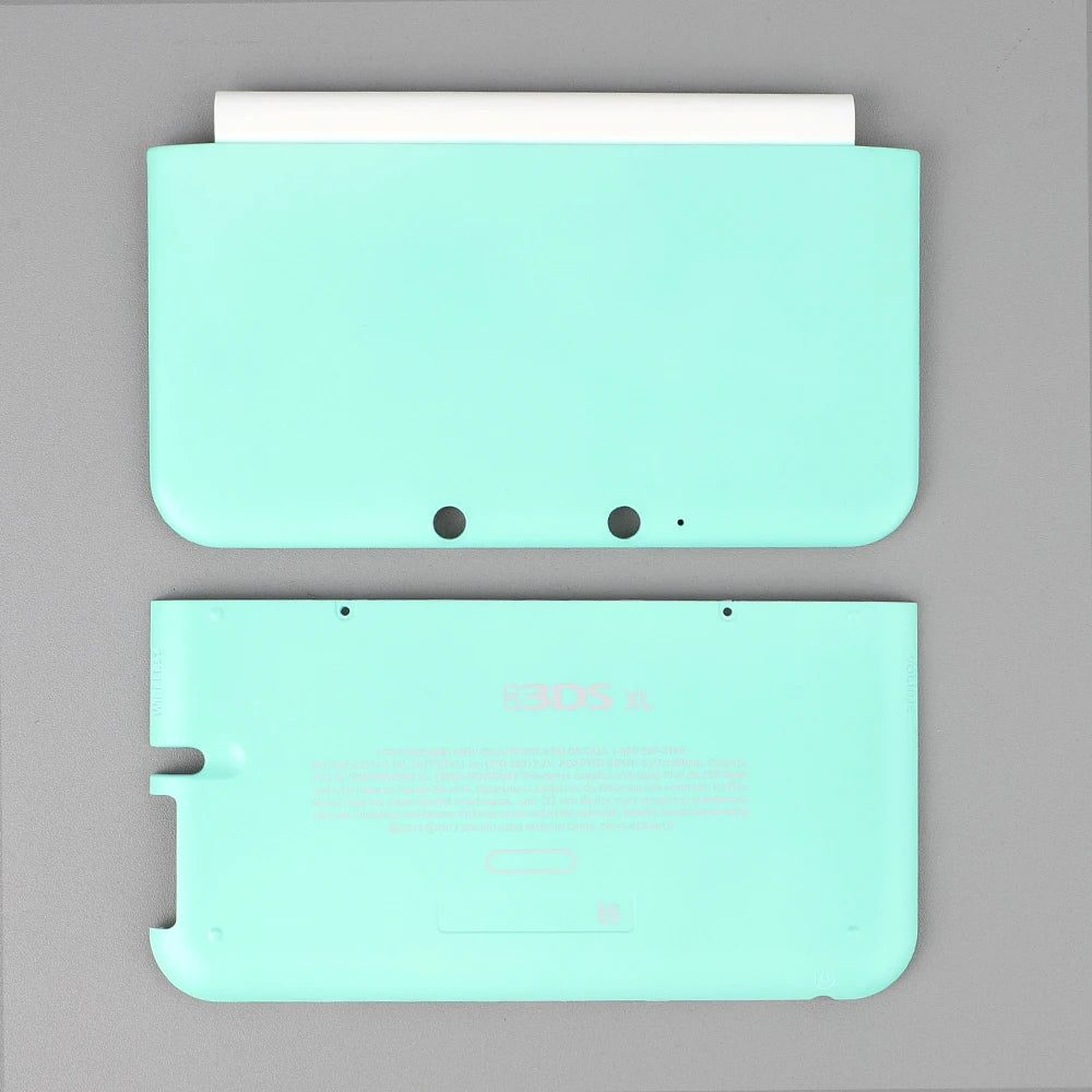 Mint green 3DS XL aftermarket front and back cover plates on a plain grey background, buy shell online UK