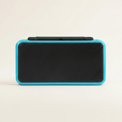 Assembled Hyper Flux New 2DS XL shell in black carbon finish with a bright cyan trim, front view