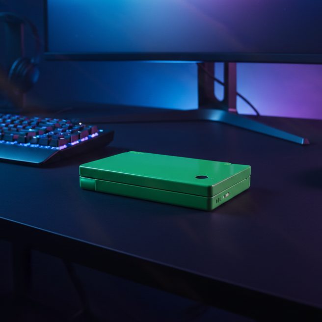 Green Jade Venom DSi housing on a gaming desk lit purple and green, modded Nintendo DSi shell UK