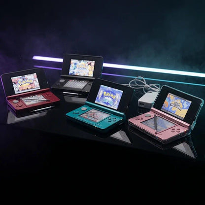 Four modded Nintendo 3DS consoles in different colours under neon lighting, CFW and preinstalled games UK