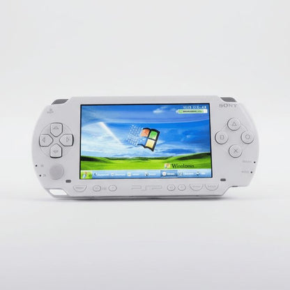 Ceramic White modded PSP 1000 studio shot showing its custom firmware home screen, emulators preloaded – ModxGaming UK