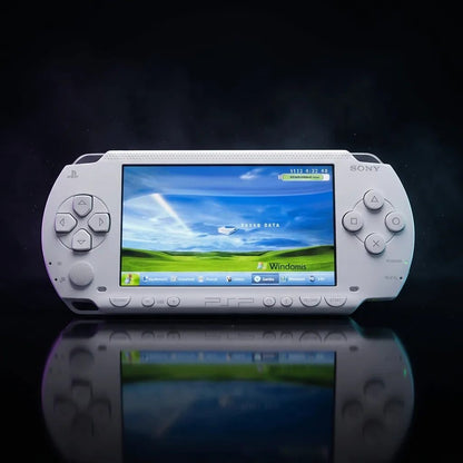 Modded PSP 1000 in white glowing on a dark backdrop with custom firmware theme on screen – retro handheld UK