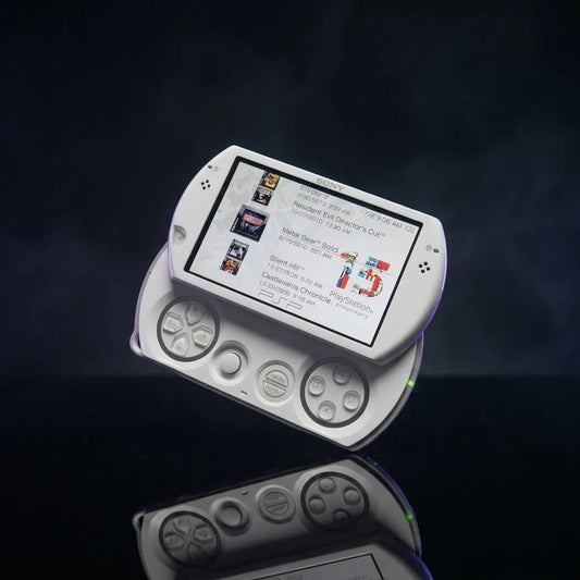 Pearl White modded PSP Go tilted on a dark backdrop with pre-installed games menu on screen – buy online UK