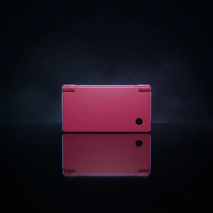 Neon Blossom DSi replacement shell in hot pink, closed console back view on a dark background