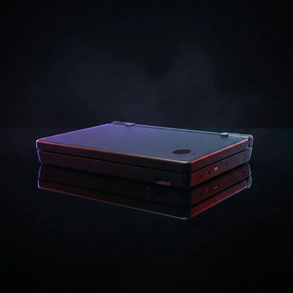 Nova Shift DSi replacement shell in black with red and purple edge glow on a reflective surface