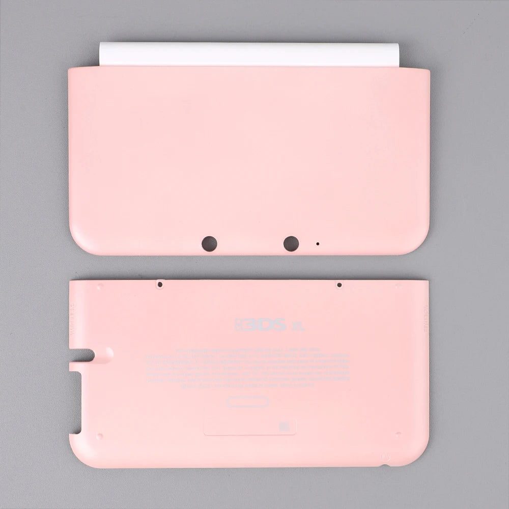 Pink 3DS XL aftermarket front and back cover plates on a plain grey background, buy replacement shell online UK