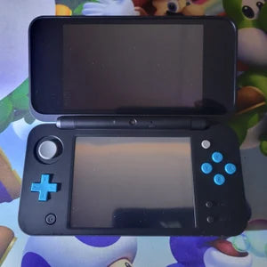 Video showing a modded Nintendo 3DS with 128GB storage running custom firmware, featuring a custom theme interface, Homebrew menu, and various installed emulator apps. Clear plastic case with branding on a blue and wooden surfacePink handheld gaming device with screen displaying 'Super Smash Bros.' game on a glittery gold surface. 3DS Modded 3DS Custom Firmware 128gb emulators, anemone, h shop, homebrew