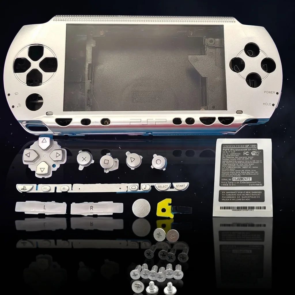 Silver PSP 1000 Phat replacement shell kit laid out with buttons and screws, modded PSP housing UK