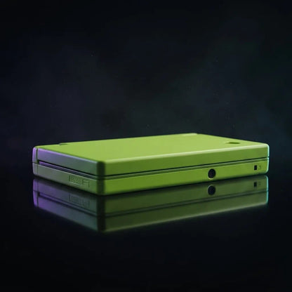 Solar Flare Yellow DSi replacement shell in vivid lime-green, closed console on a dark background