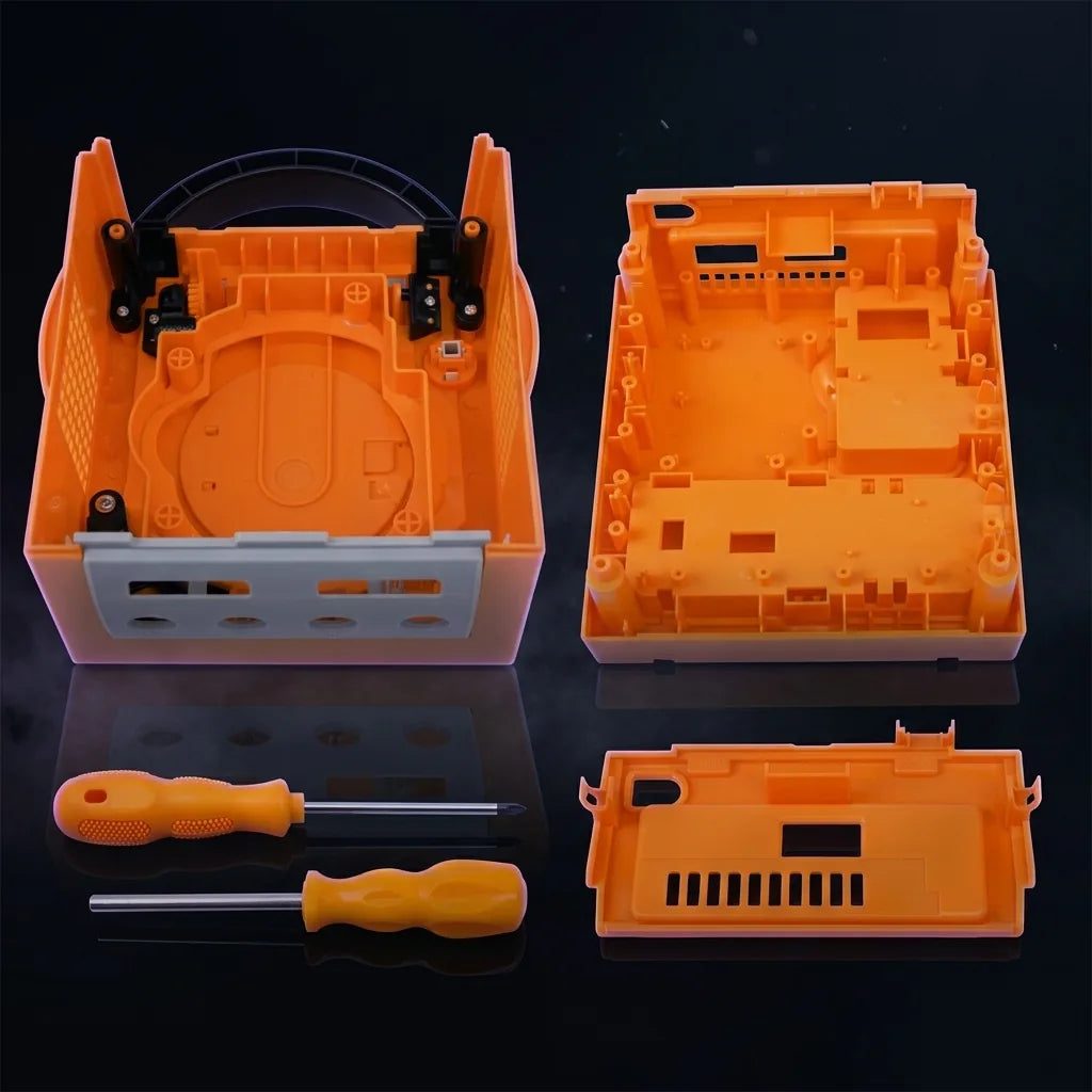 Yellow Nintendo GameCube replacement shell halves laid out with screwdriver tools, modded GameCube housing kit UK