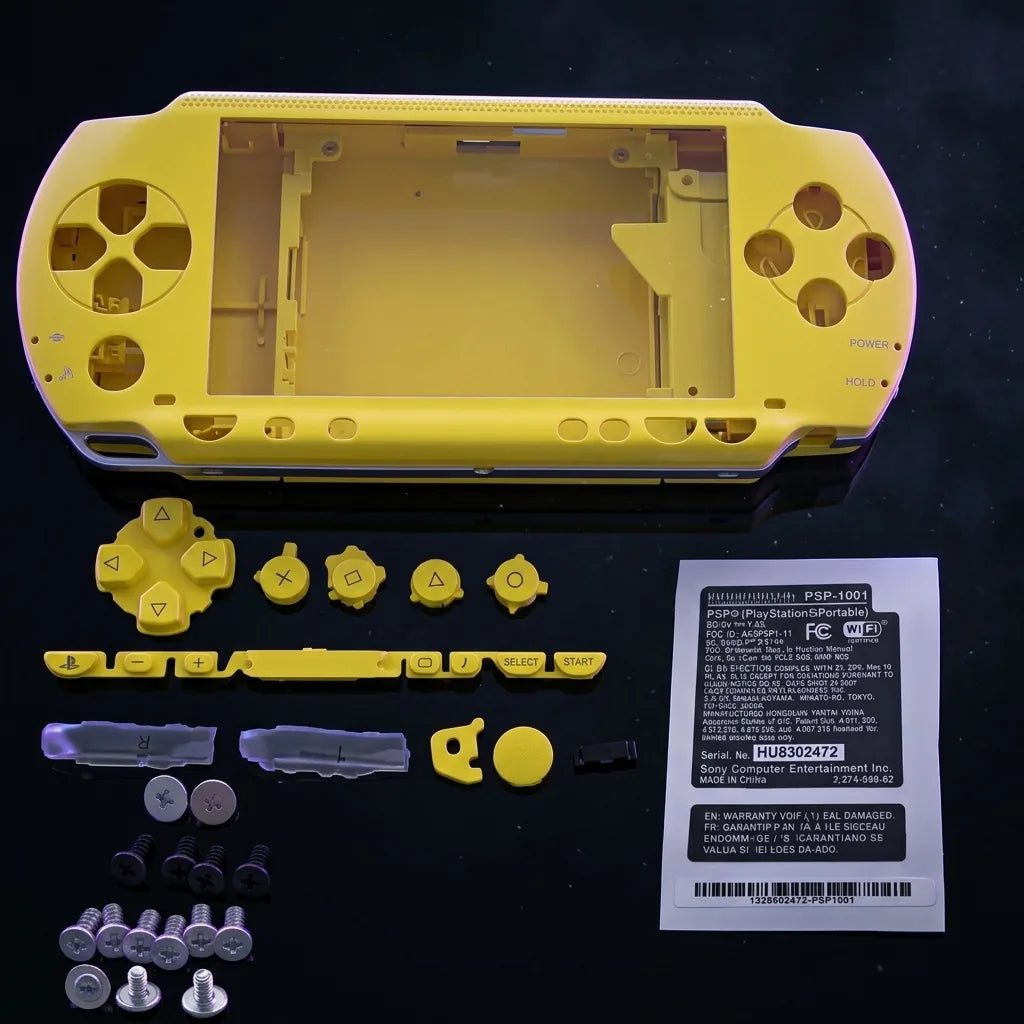 Yellow PSP 1000 Phat replacement shell kit laid out with buttons and screws, modded PSP housing UK
